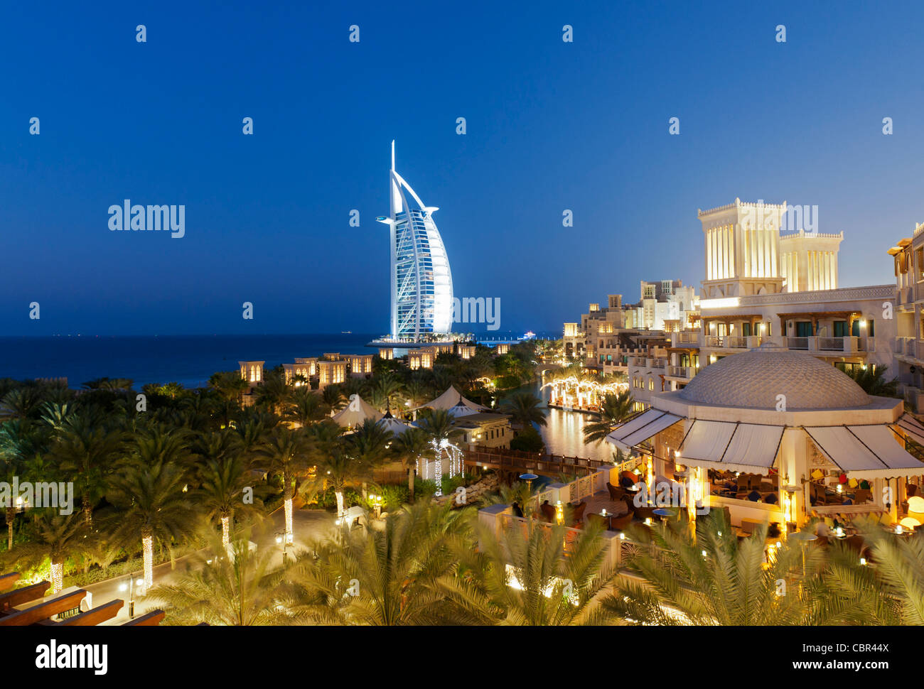 View of resort hotels at Jumeirah Madinat and Burj al Arab hotel at night  in Dubai in United Arab Emirates Stock Photo