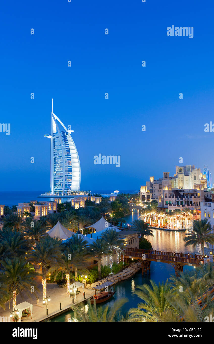 View of resort hotels at Jumeirah Madinat and Burj al Arab hotel at night in Dubai in United Arab Emirates Stock Photo