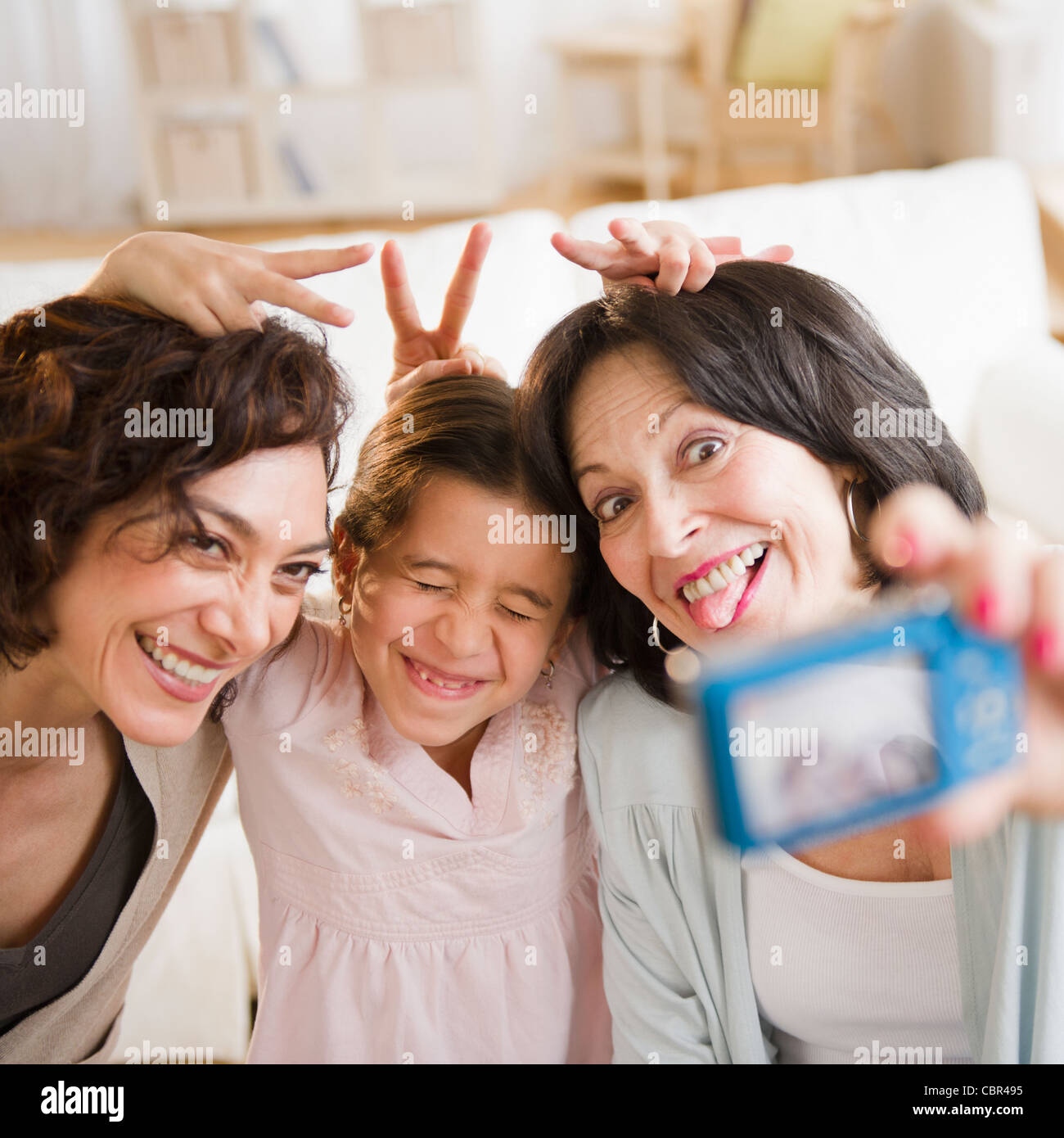 Family taking self-portrait with digital camera Stock Photo