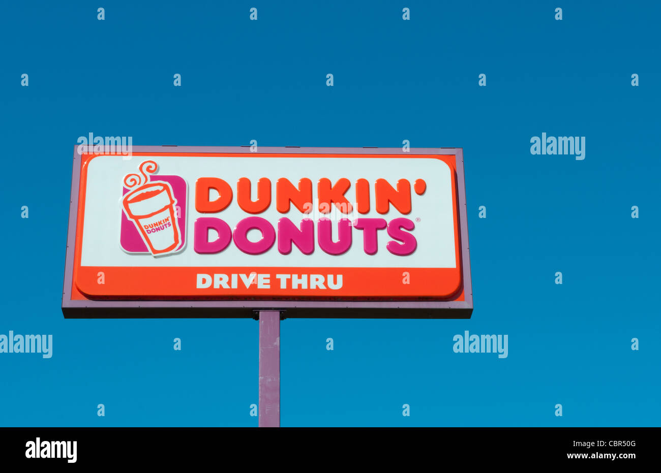 Famous Dunkin Donut sign logo an American Corporation in the blue sky