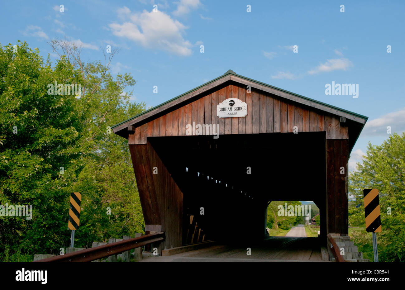 Covered Bridges of Vermont by river with rocks Gorham Bridge in