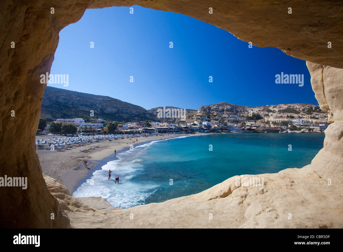 Matala beach seen from inside a cliff cave, Matala, Crete, Greece. Stock Photo