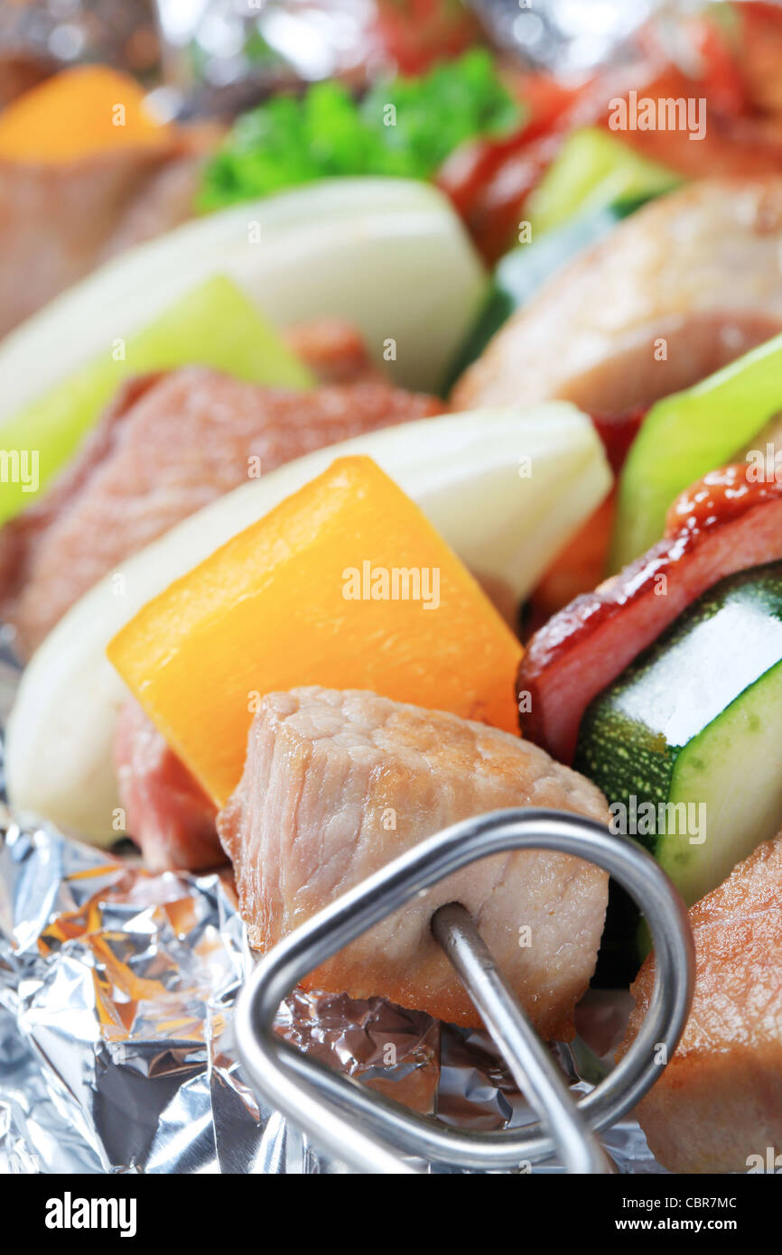 Pork and vegetable skewers in aluminum foil Stock Photo