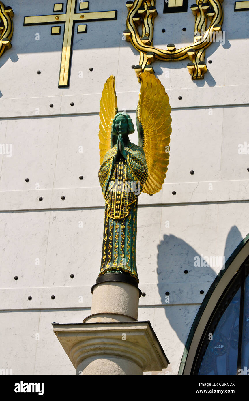 statue of a golden art nouveau angel praying on vienna's otto wagner church Stock Photo