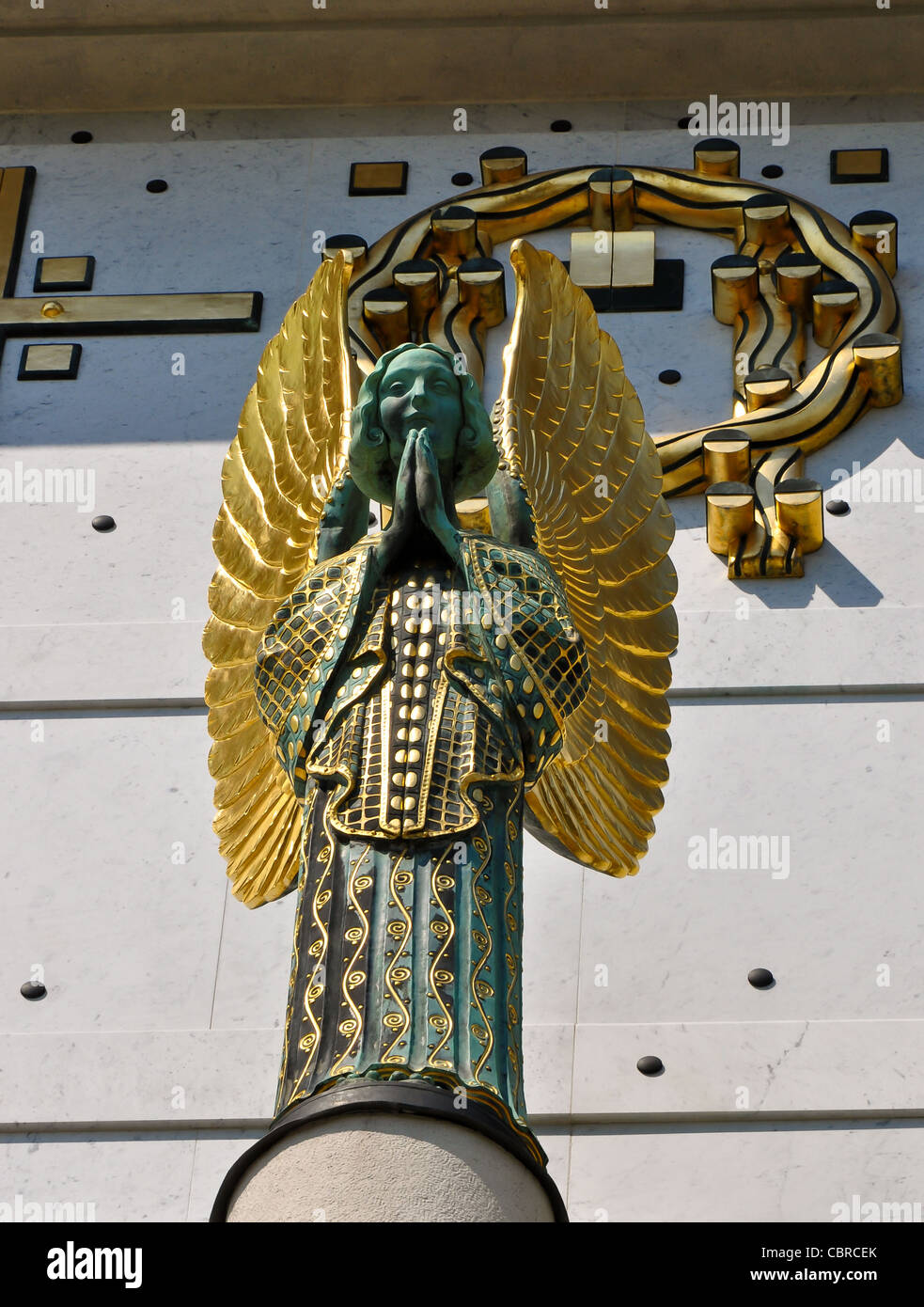 statue of a golden art nouveau angel praying on vienna's otto wagner church Stock Photo