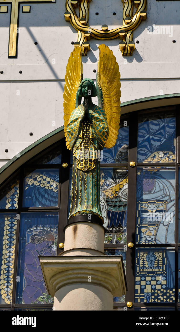 statue of a golden art nouveau angel praying on vienna's otto wagner church Stock Photo