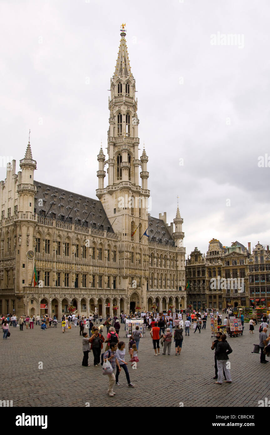 Vertical wide angle view of the amazing Gothic architecture of Brussels Town Hall in a crowded Grand Place. Stock Photo