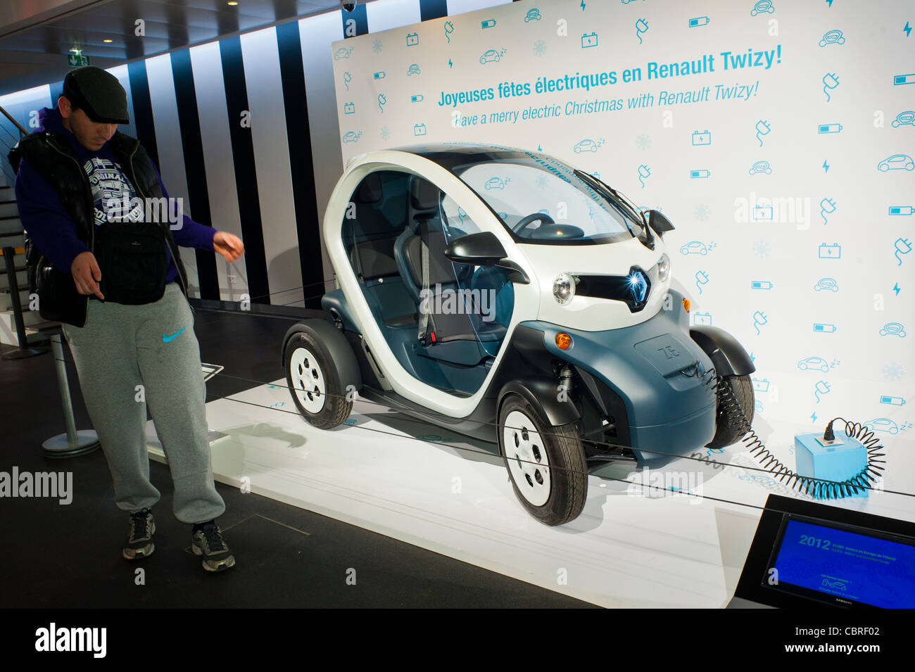 Paris, France, People visitjng inside New Car Showroom, Looking at Renault Mini Electric Car the "Twizy" on Display Cars, global green economy concept, side view, france innovation Stock Photo