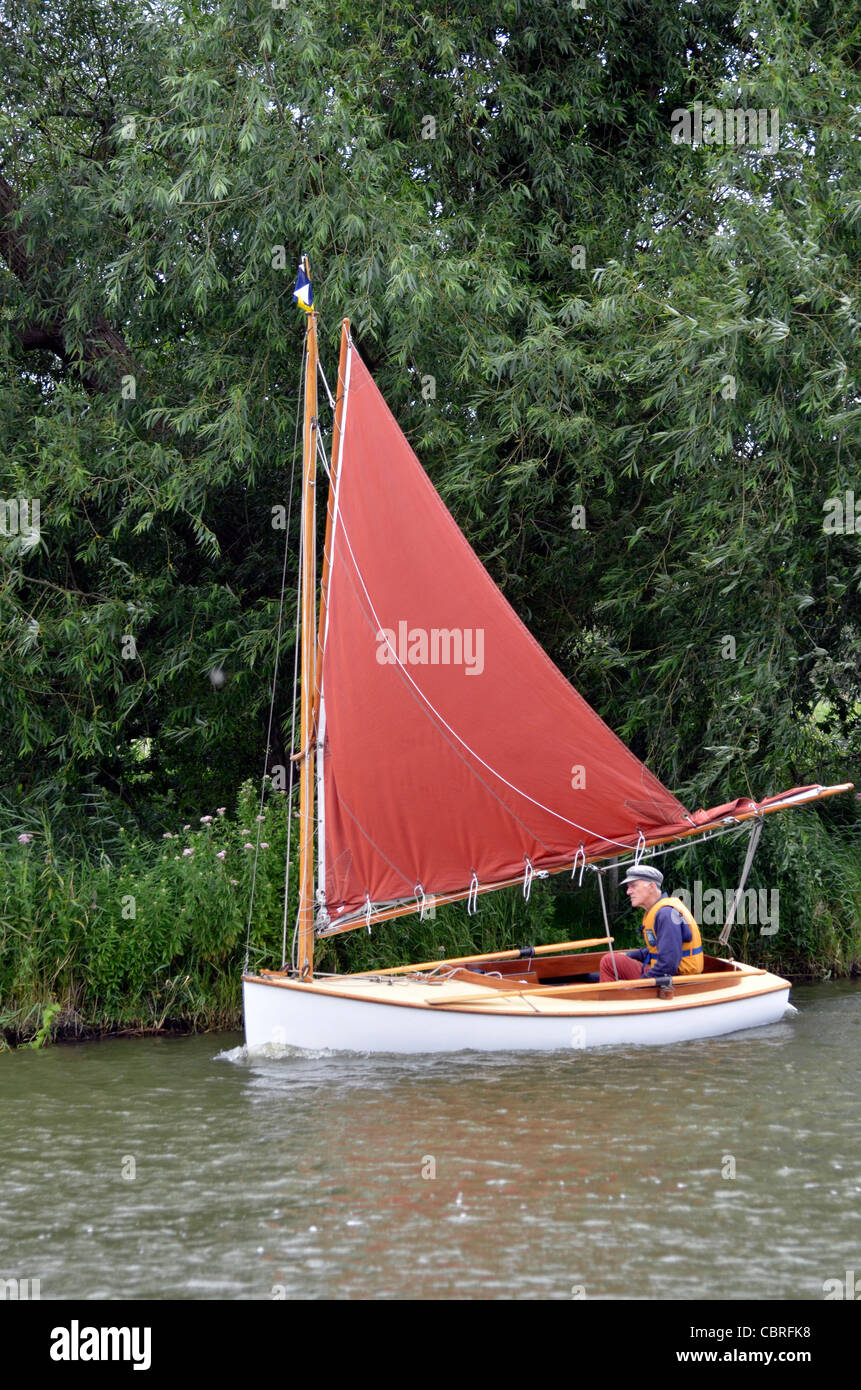 pensioner sailing dinghy single handed on norfolk broads Stock Photo