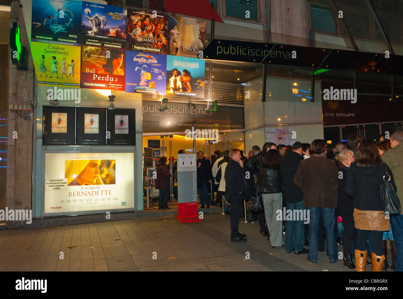 Paris, France, People going to the cinema, Queuing on Line in front of French Cinema Movie Theatre Exterior, Marquee, at Night Exterior, on Avenue Champs ELysees 'Drugstore Publicis' french films Stock Photo