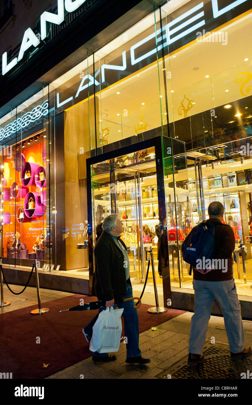 Paris, France, Couple Shoppers, Shopping, Luxury Fashion Brands, Clothing Store, Lancel, Shop Front Window at Night on Avenue Champs ELysees Stock Photo