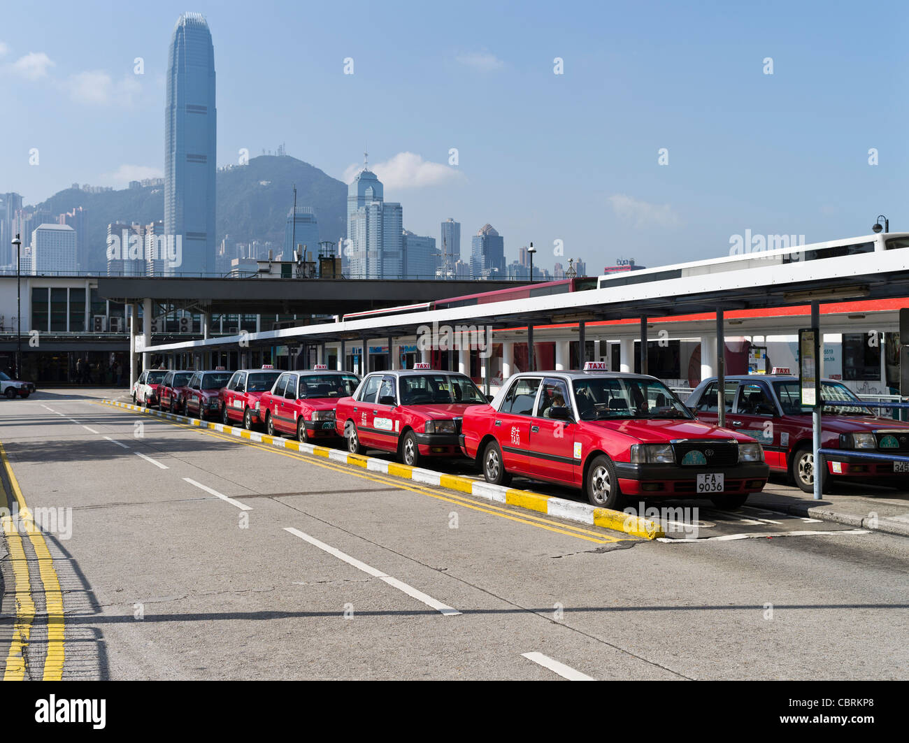 dh  TSIM SHA TSUI HONG KONG Tsim Sha Tsui Ferry Pier taxi rank with red taxis Stock Photo