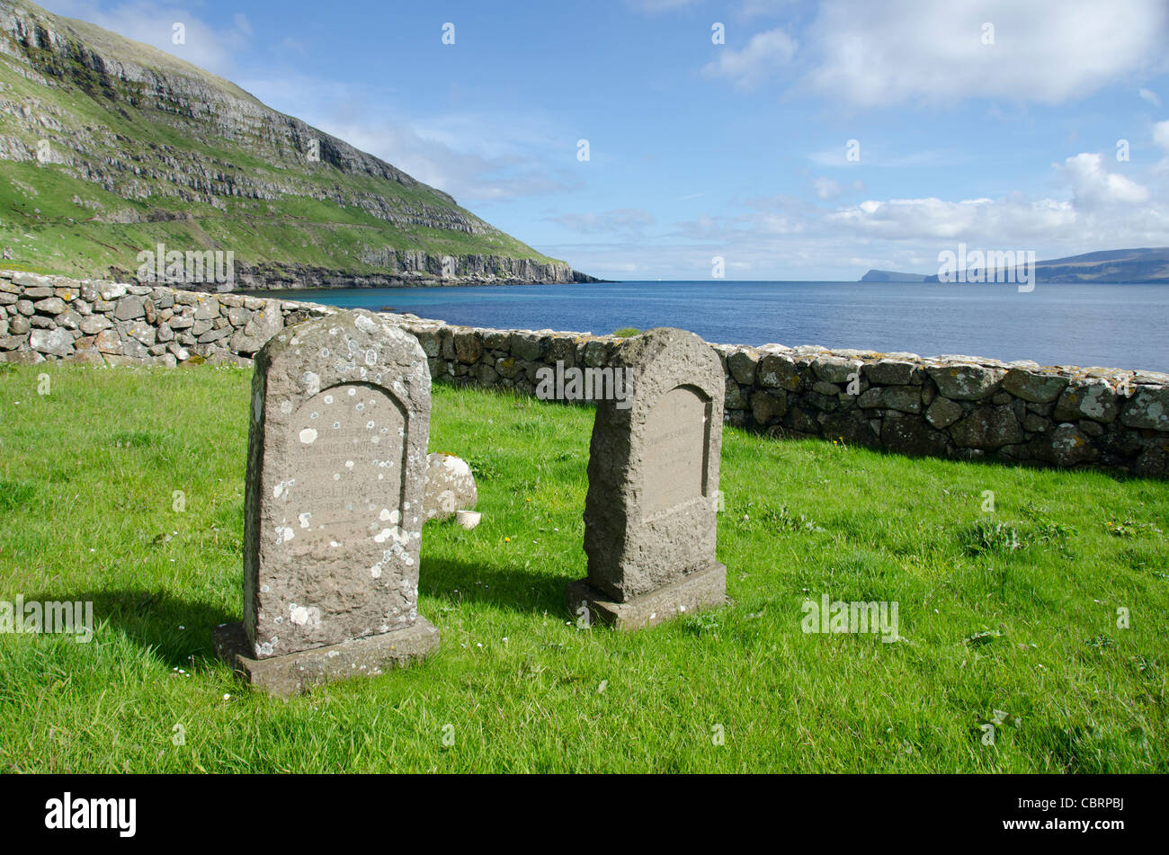 Kingdom of Denmark, Faroe Islands. Historic medieval church of Kirkjubour, old graveyard. Stock Photo