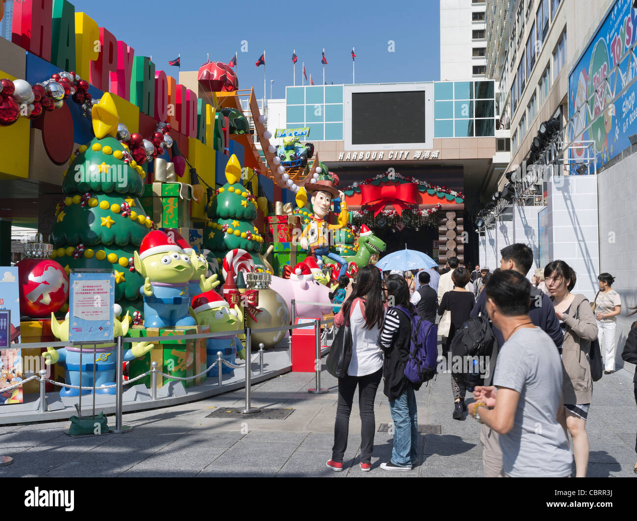 dh  TSIM SHA TSUI HONG KONG Hong Kong chinese looking at Disney characters display cowboy Woody Stock Photo