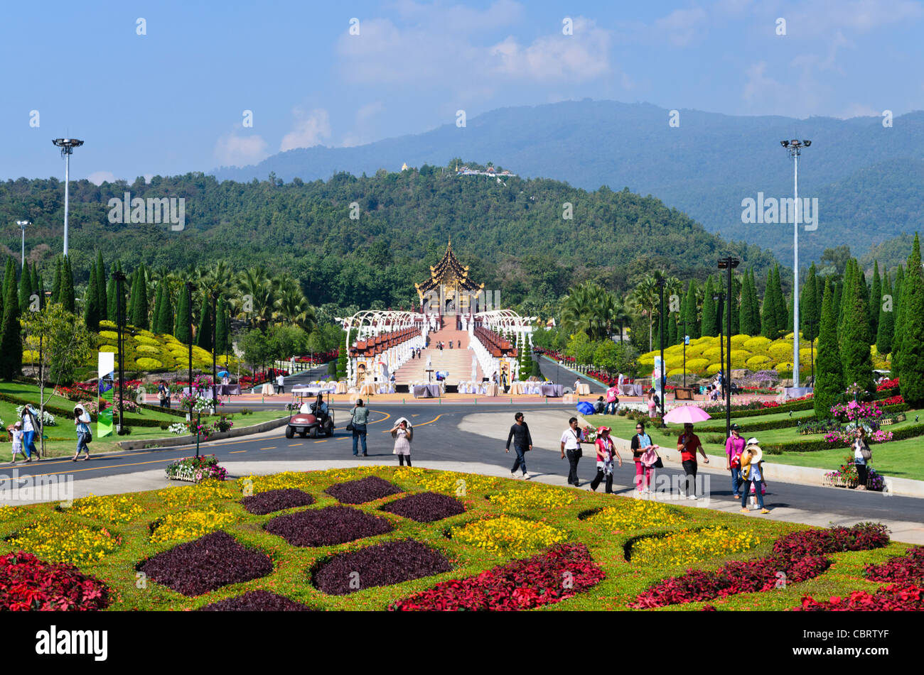 Floral landscaping in front of long walkway leading to the Royal Pavilion at Royal Flora Ratchaphruek in Chiang Mai Thailand Stock Photo