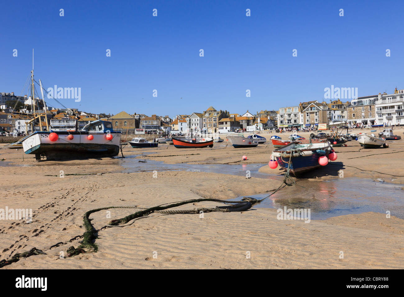 St Ives, Cornwall, England, UK. View of moored boats in the sandy harbour at low tide Stock Photo