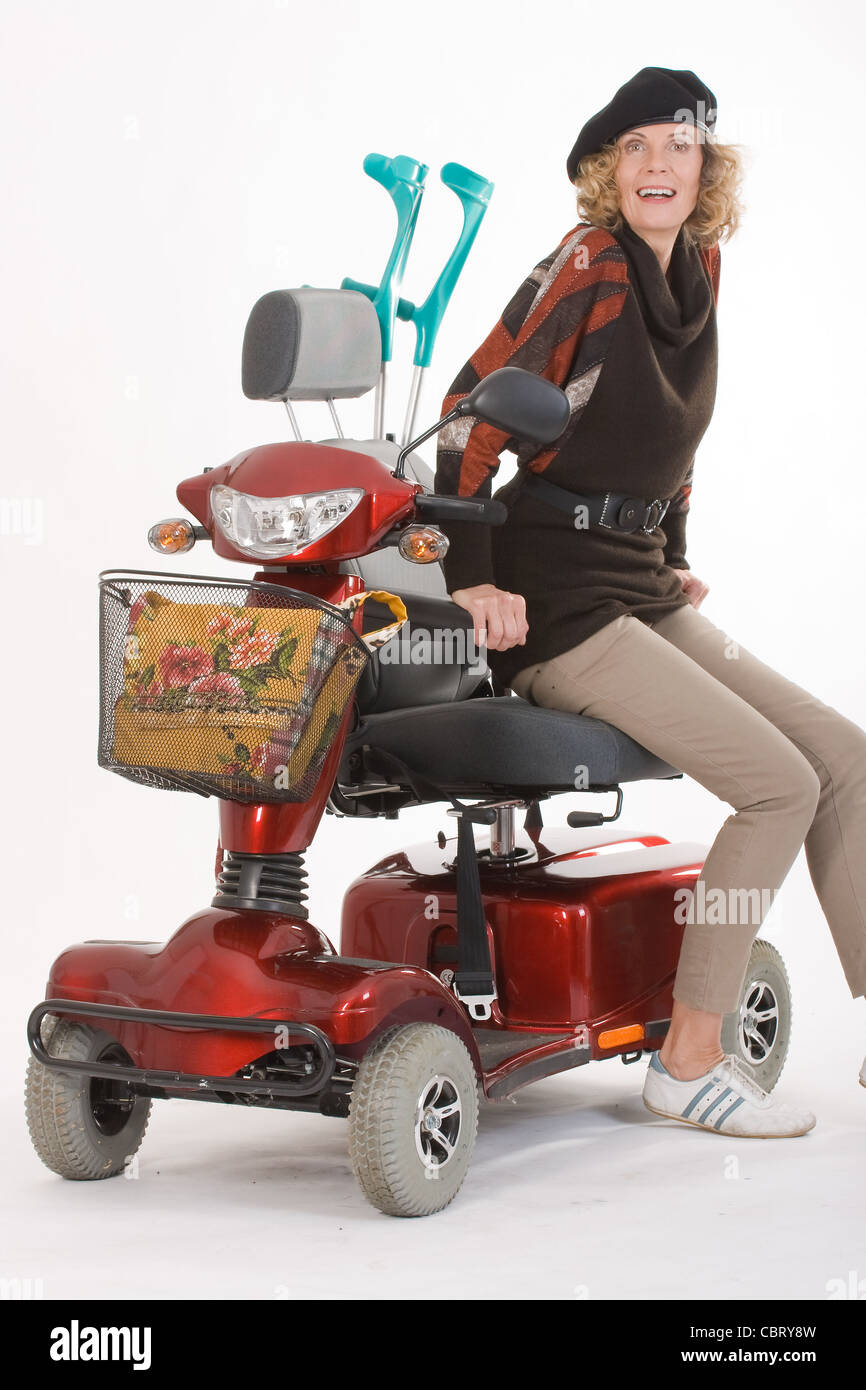 Disabled elderly woman with scooter Stock Photo