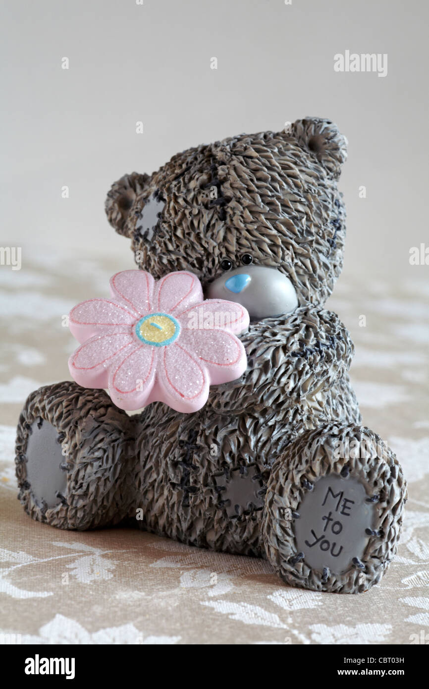 Me to You money box bear sitting holding a pink daisy Stock Photo - Alamy