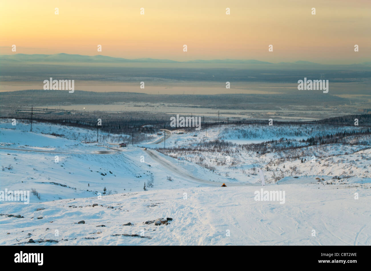 Polar night and snowy road in mountains in northern tundra in Kola Peninsula, Kirovsk, Russia Stock Photo