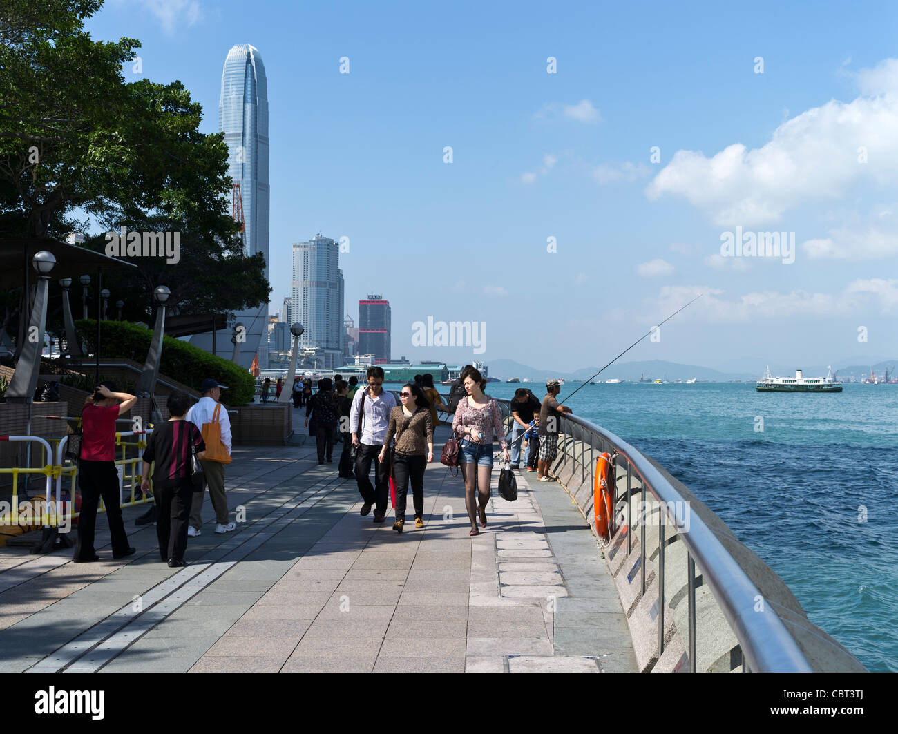 dh Expo Wan Chai Promenade WANCHAI WATERFRONT HONG KONG ISLAND People walking Central skyline front waterfront victoria harbour Stock Photo