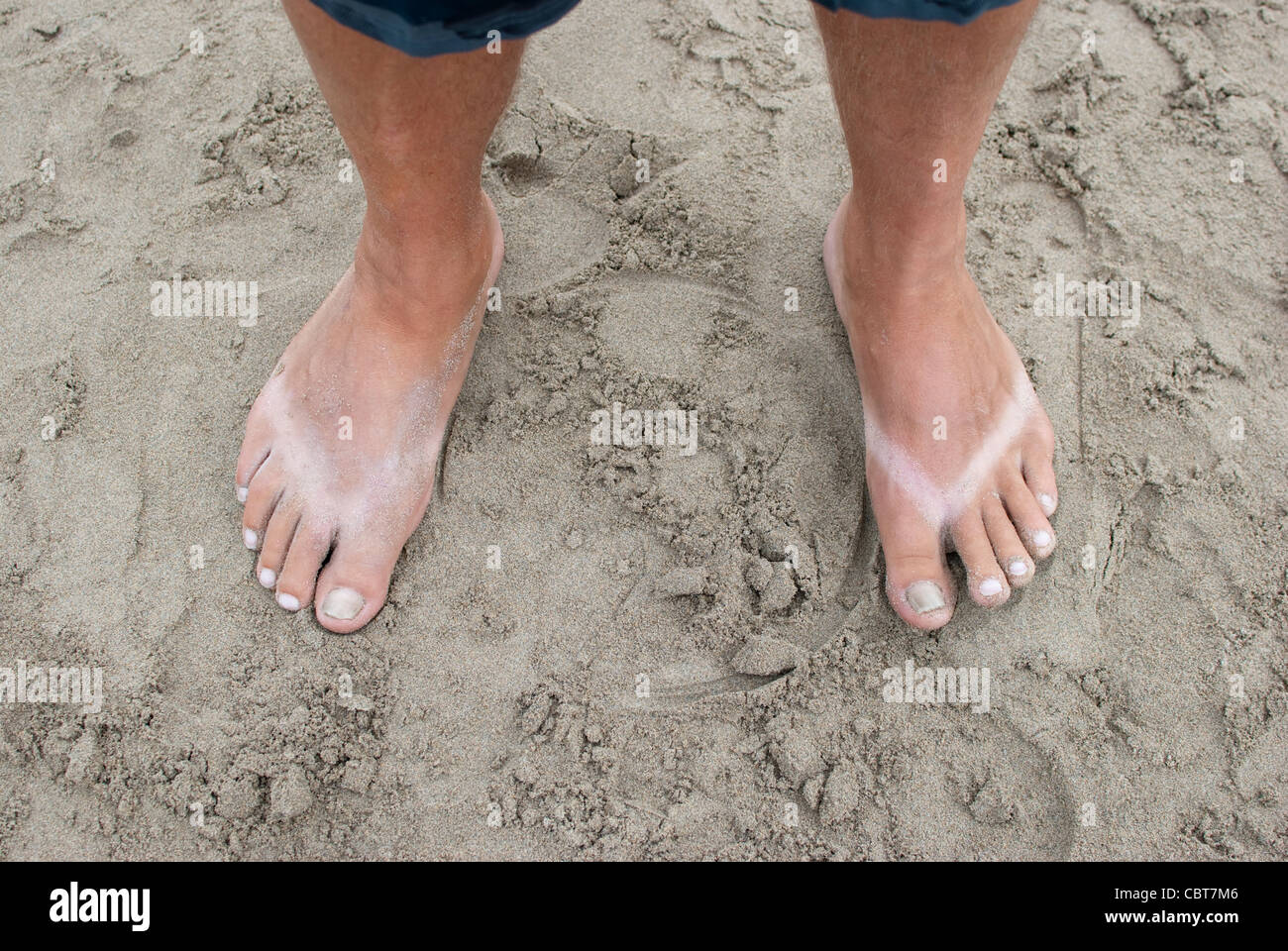 Tanned feet on a beach Stock Photo - Alamy