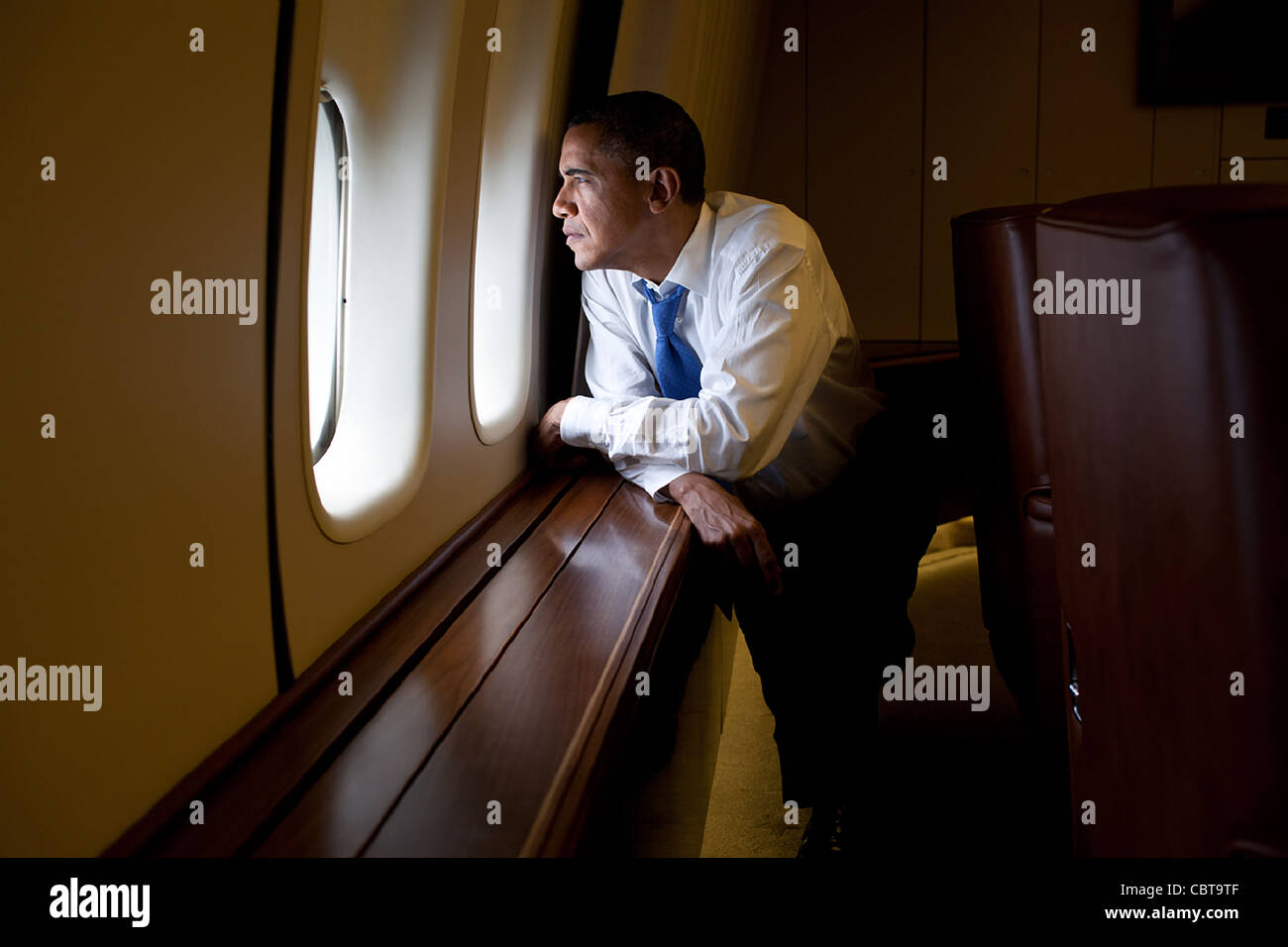 President Barack Obama looks out a window of Air Force One during the flight from Canberra to Darwin, Australia November 17, 2011. Stock Photo