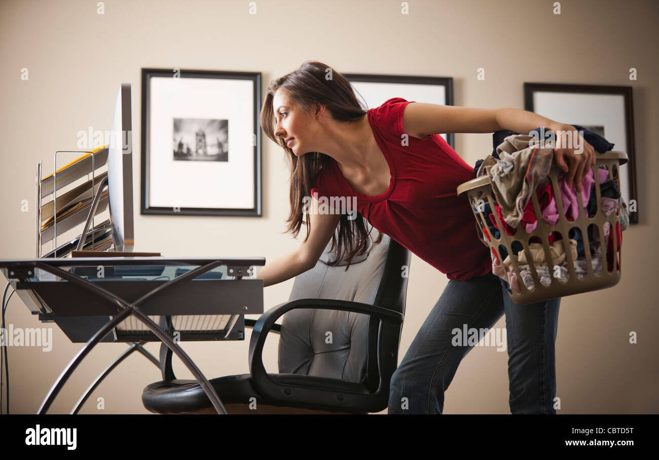 Caucasian woman multi-tasking home office Stock Photo