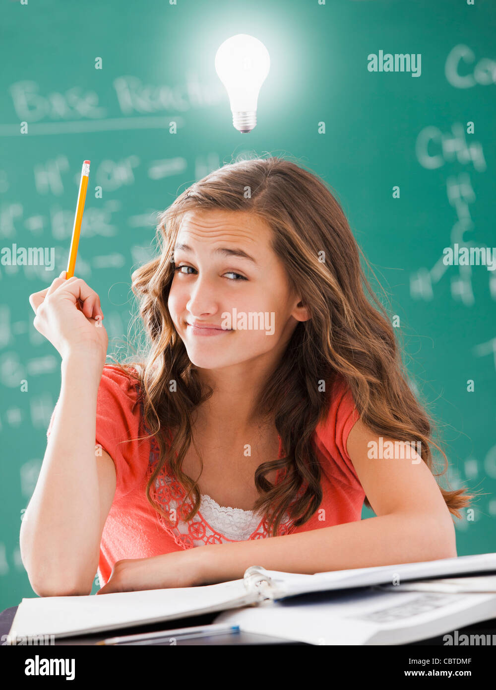 Caucasian student with light bulb over her head Stock Photo