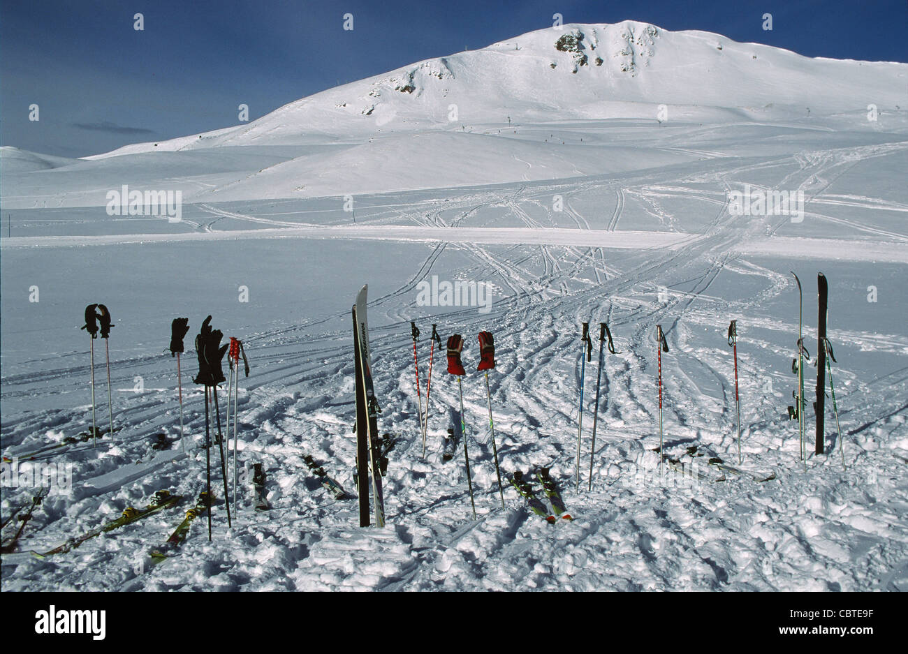 Ski sticks and skis stuck into the snow of the skiing area Saint-Lary 2400 in Midi-Pyrénées Stock Photo