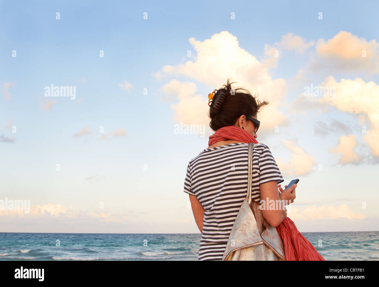 Woman reading phone rear view hi-res stock photography and images - Alamy