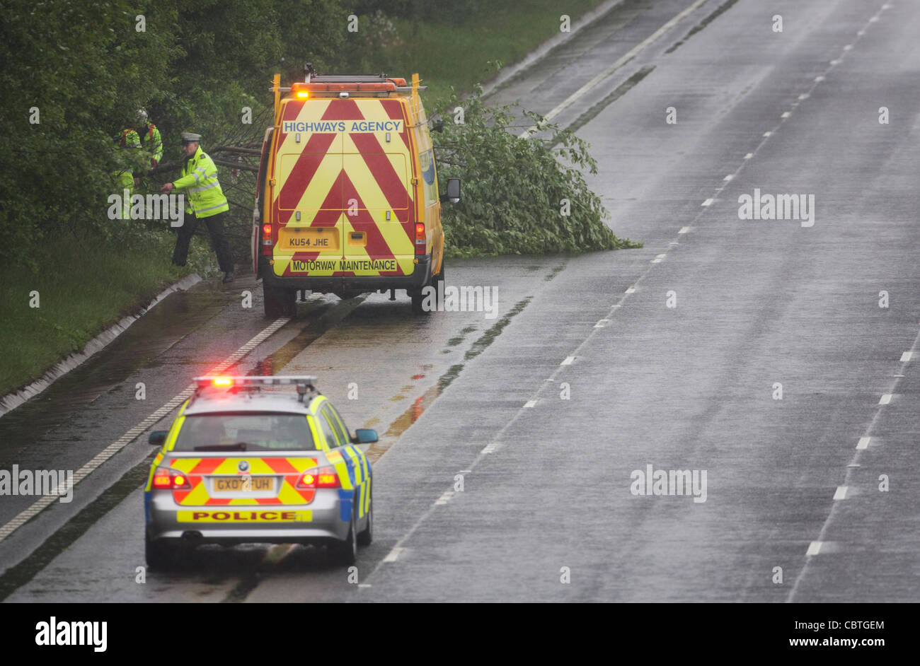 Clearing fallen tree from road hi-res stock photography and images - Alamy