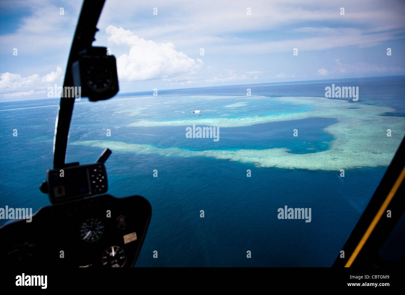 Aerial views incorporating the helicopter interior over the stunning Great Barrier Reef, Australia. Stock Photo