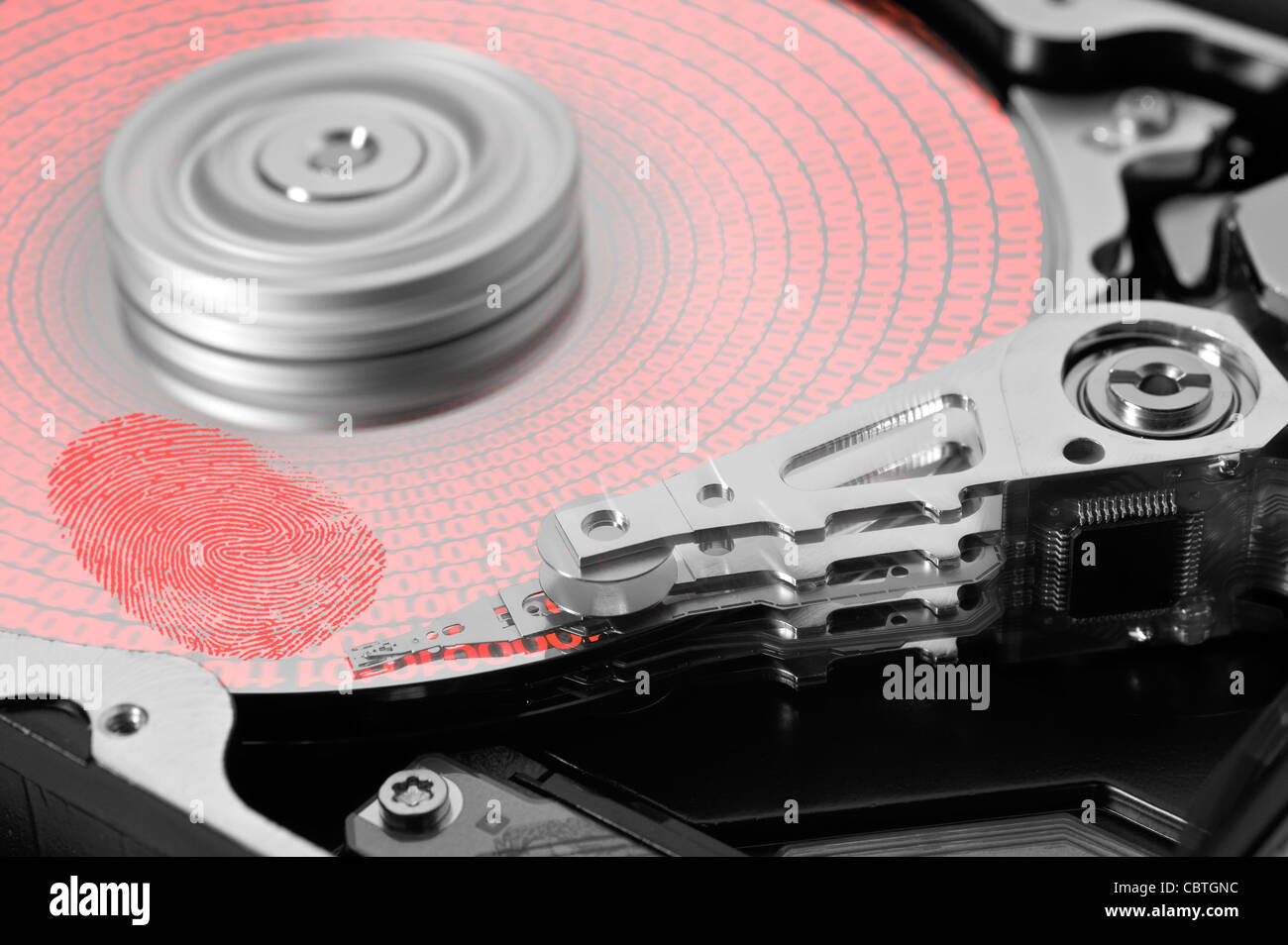 symbolic theme around data security showing a open hard disk with symbolic fingerprint and data Stock Photo