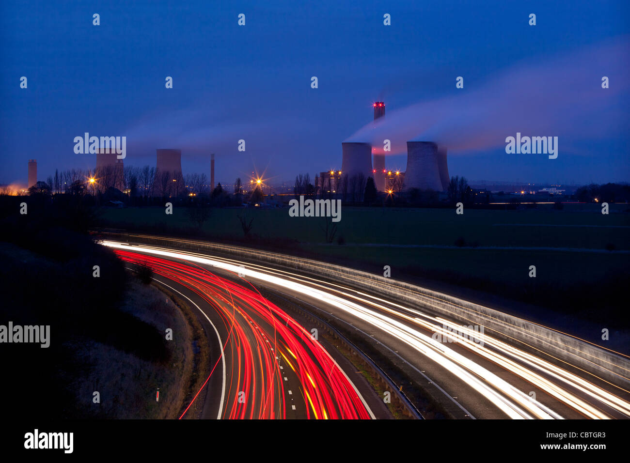 Traffic at night running past a coal fired electricity generating power station, Didcot, oxon, uk Stock Photo