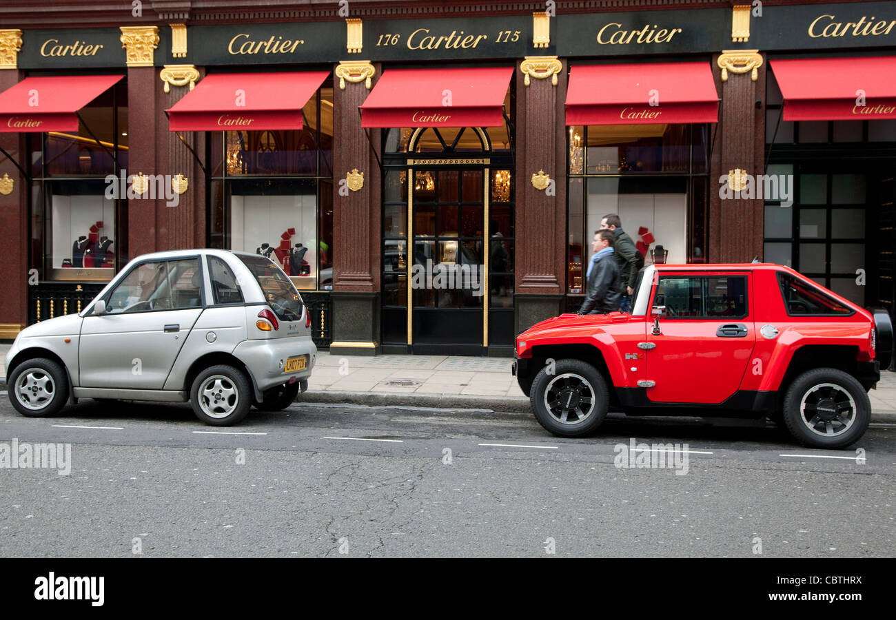 Tiny cars including G-Wiz electric and Hummer HX parked outside Cartier jewellers, Mayfair, London Stock Photo