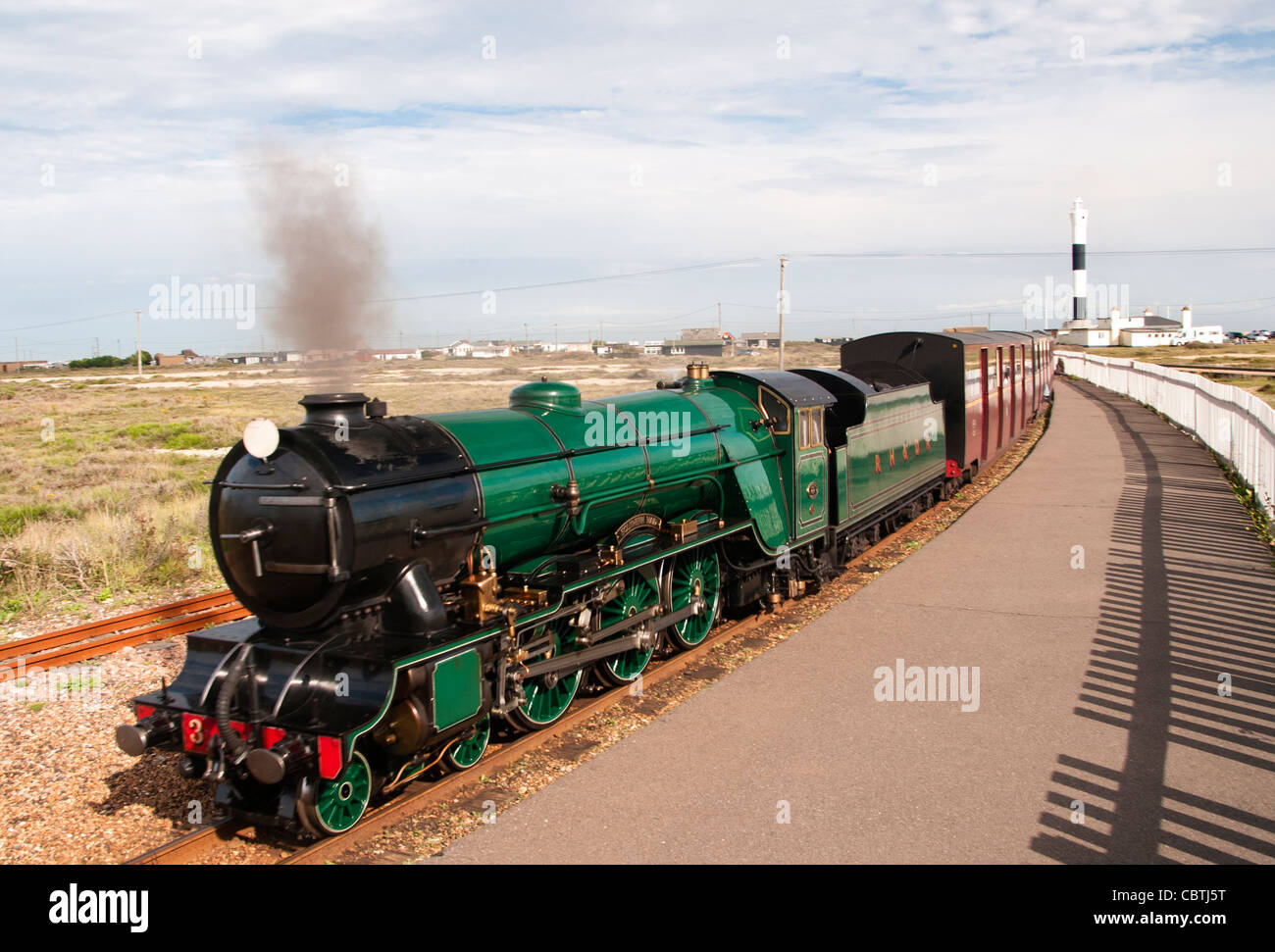 Romney, Hythe and Dymchurch Railway train with the lighthouse in the ...