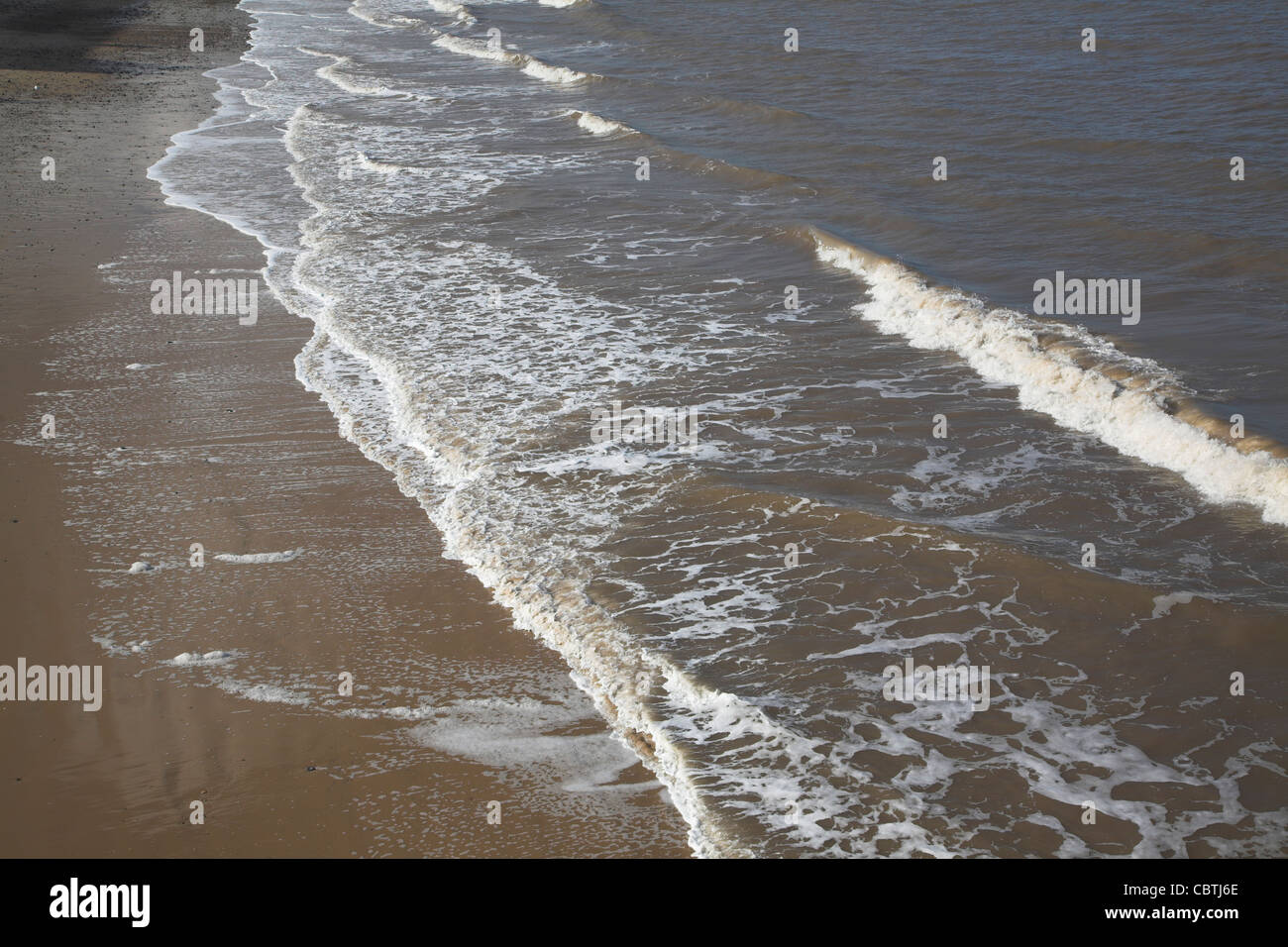 Waves break on beach, Cromer, Norfolk, England Stock Photo
