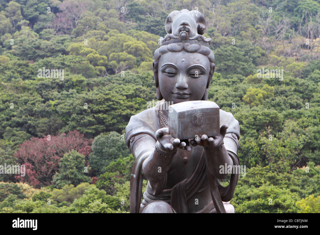 A Buddhistic statue making an offering to the Tian Tan Buddha in Hong Kong Stock Photo