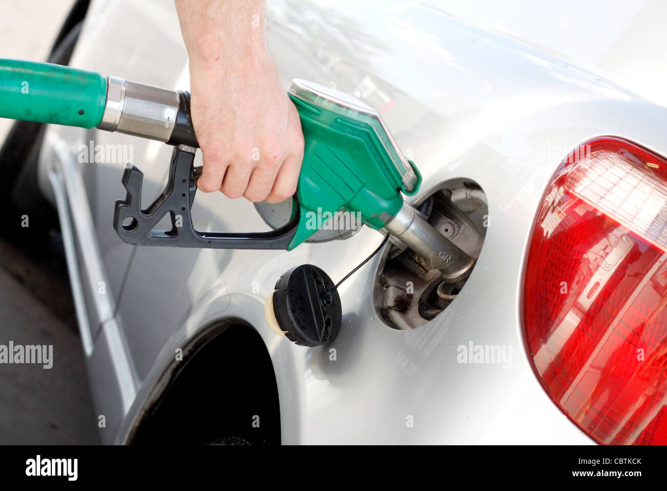 A man pumping gas in to the tank Stock Photo Alamy