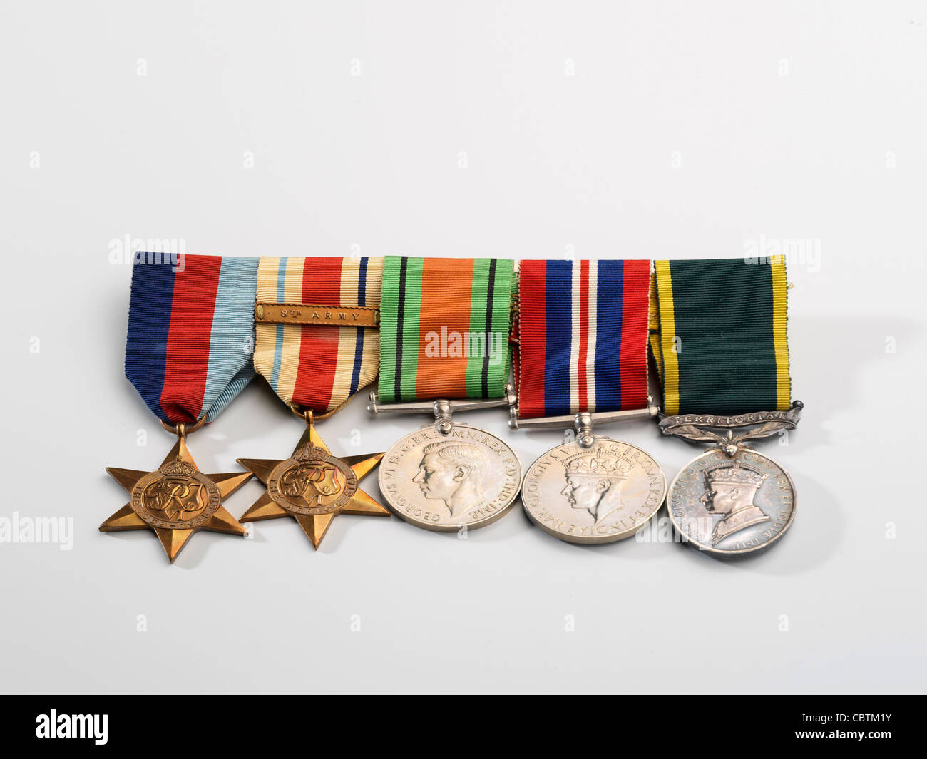 Medals awarded during WW2, including the 8th Army Africa Star, The Defence Medal, and The Territorial Army Medal. Stock Photo