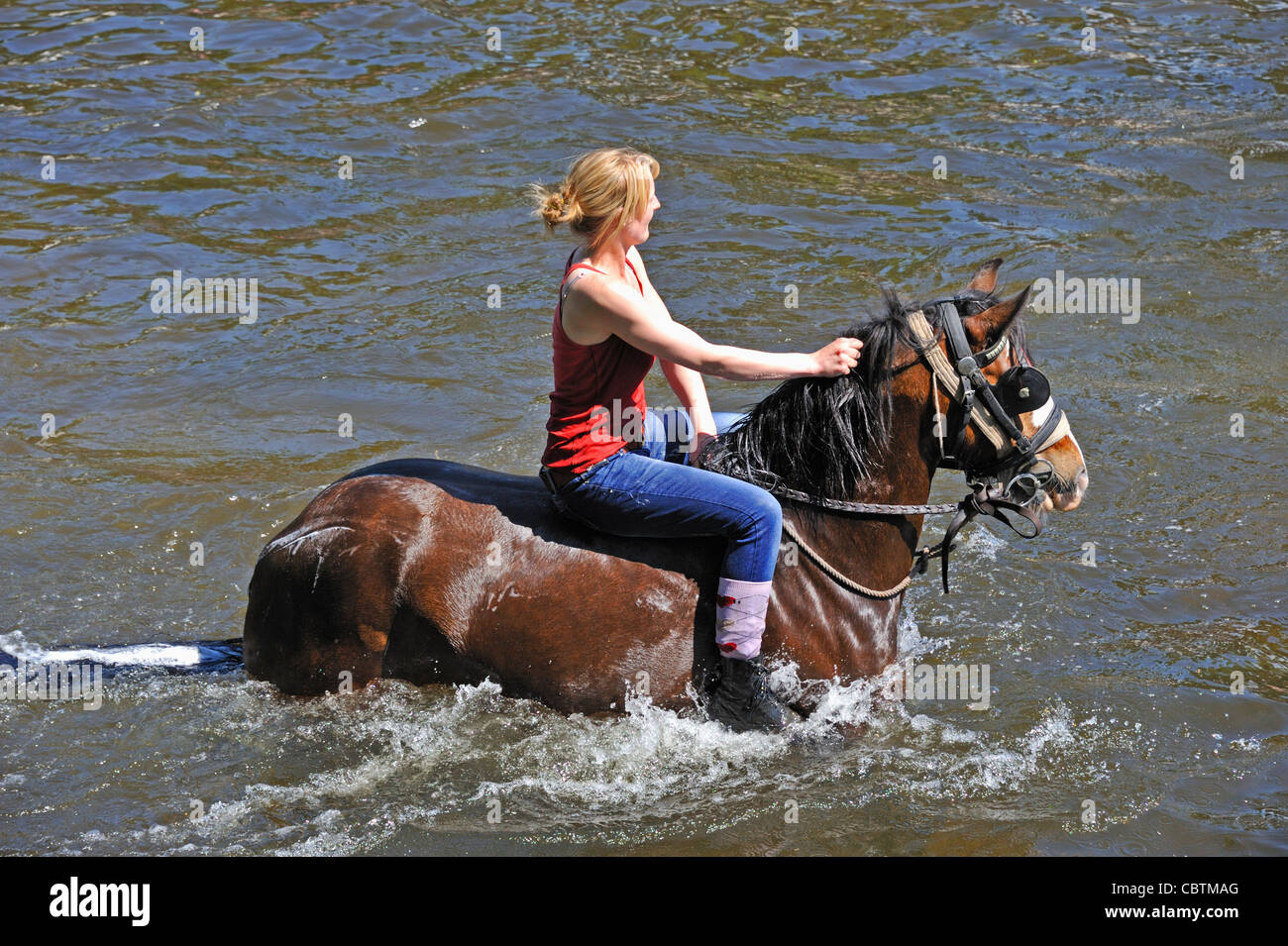 Gypsy traveller girl riding horse in River Eden. Appleby Horse Fair. Appleby-in-Westmorland, Cumbria, England, United Kingdom. . Stock Photo