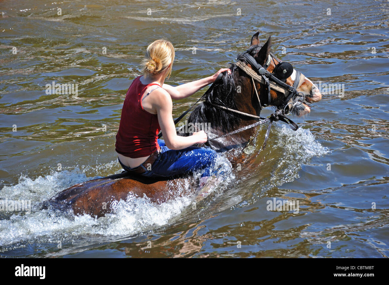 Gypsy traveller girl riding horse in River Eden. Appleby Horse Fair. Appleby-in-Westmorland, Cumbria, England, United Kingdom. . Stock Photo