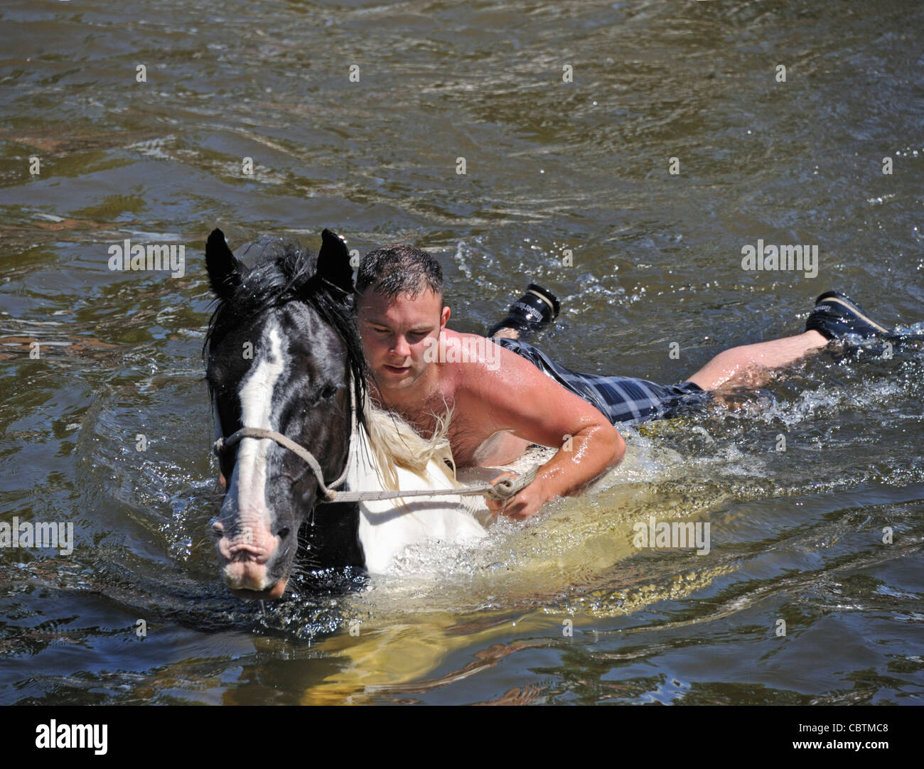 Gypsy traveller boy riding horse in River Eden. Appleby Horse Fair. Appleby-in-Westmorland, Cumbria, England, United Kingdom. . Stock Photo
