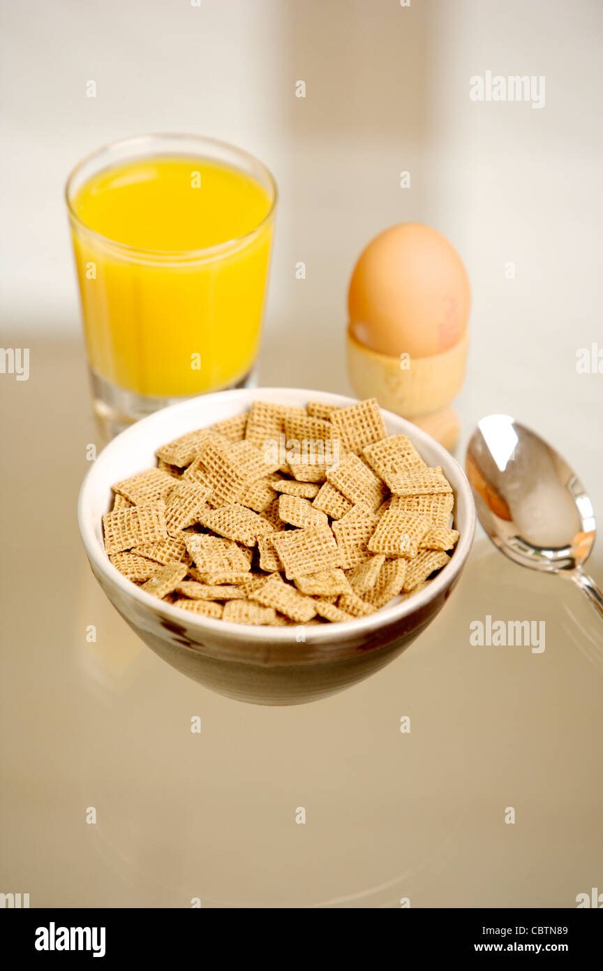 Breakfast cereal on a glass table with coffee, Orange Juice, toast, boiled egg Stock Photo