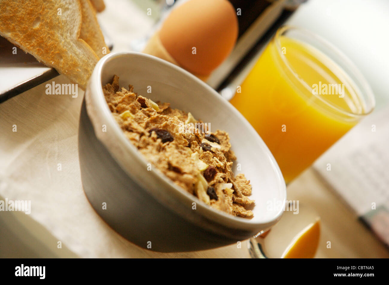 Breakfast cereal on a glass table with coffee, Orange Juice, toast, boiled egg Stock Photo