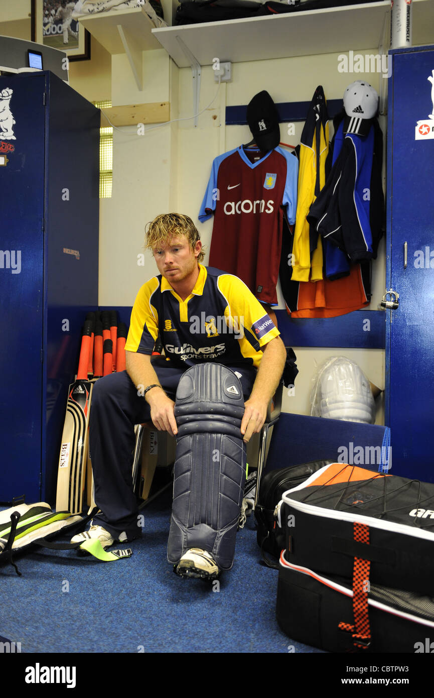 Warwickshire cricketer Ian Bell padding up to bat in dressing room Stock Photo