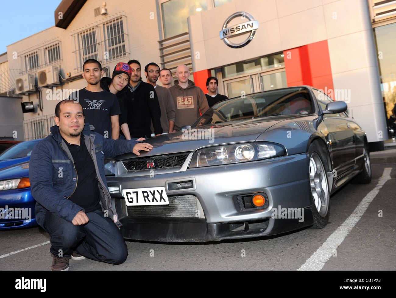 Nissan R33 GTR owner Emil Ahmed of Birmingham with his classic car and other classic car owners. Stock Photo