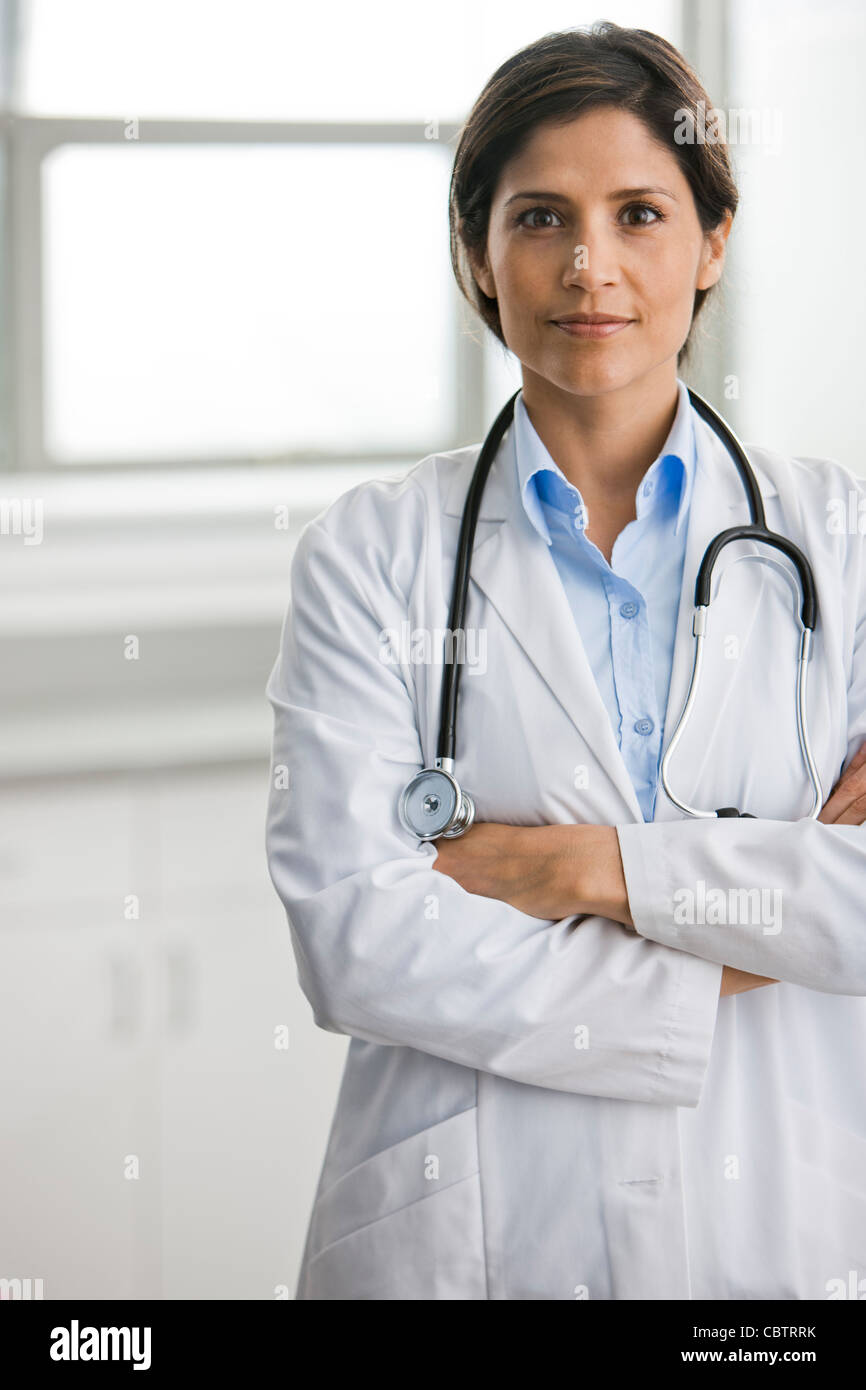 Hispanic doctor with arms crossed Stock Photo