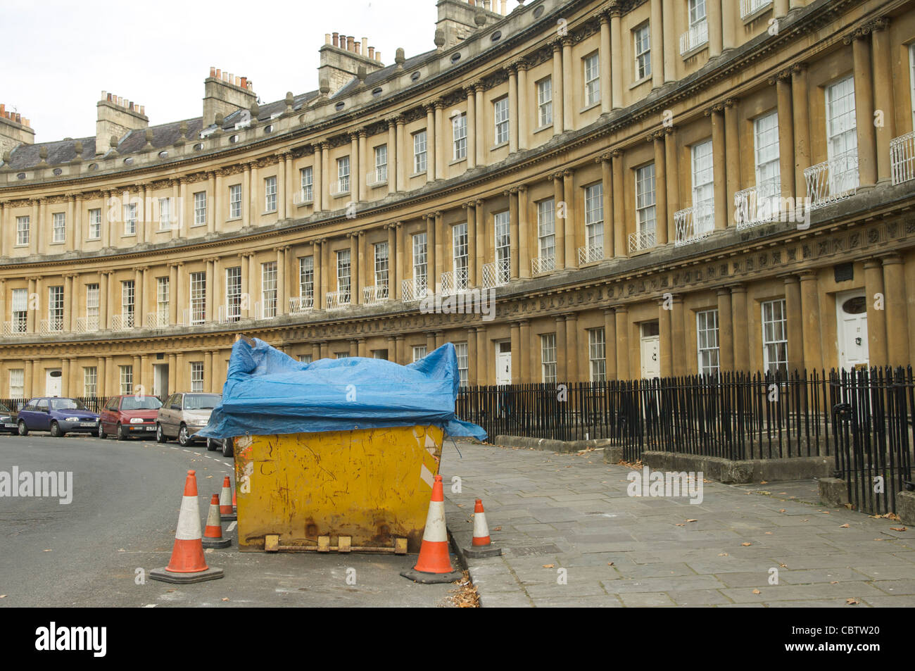 Builders skip and cars parked in front of the elegant Bath Circus in the City of Bath Spa,Somerset,UK Stock Photo