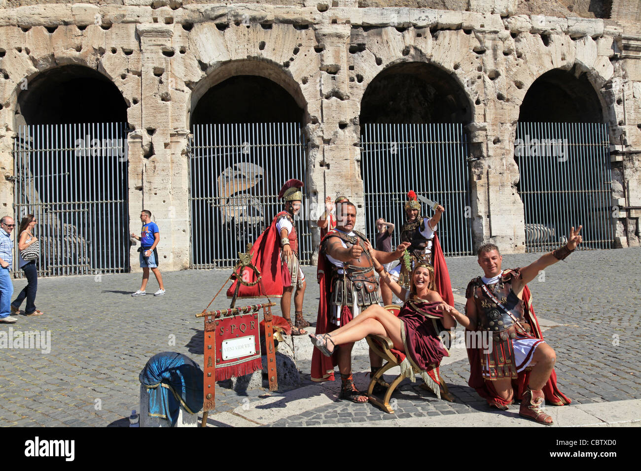 Street performers dressed as ancient Roman soldiers in front of the Coliseum, Rome Stock Photo